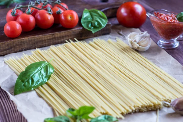 Pasta ingredientes. tomate, ajo, pimienta y aceite en bac de madera — Foto de Stock