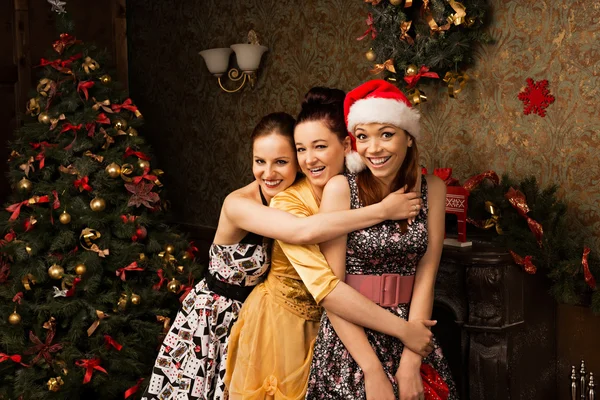 Portrait of  three young woman posing near decorated Christmas t — Stock Photo, Image