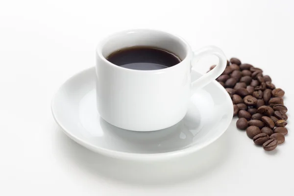 Coffee cup and beans on a white background. Stock Image