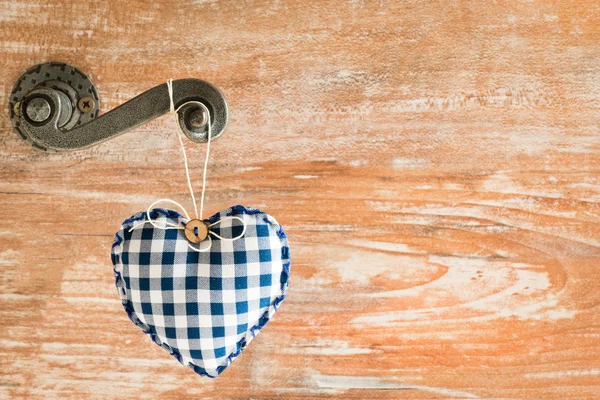 Heart shaped toy on door handle — Stock Photo, Image