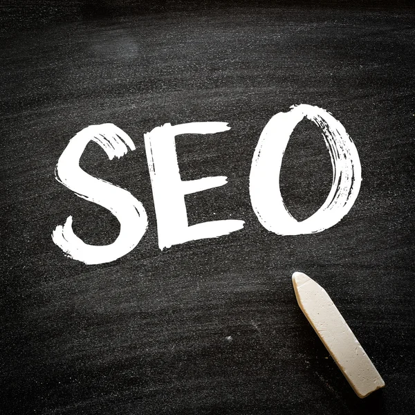 SEO word handwritten on blackboard — Stock Photo, Image