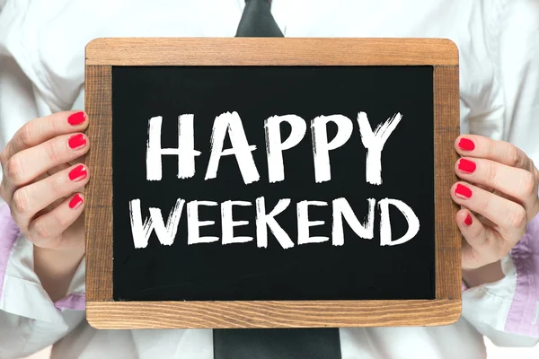 Hands with Happy weekend inscription on blackboard — Stock Photo, Image