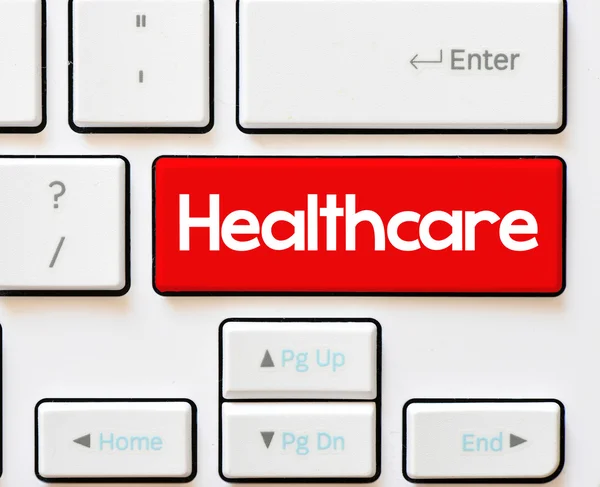 Healthcare inscription on white keyboard — Stock Photo, Image