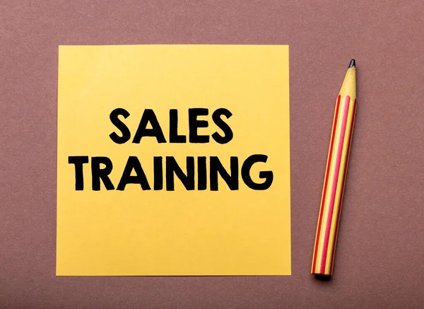 Sales training text on the yellow small piece of paper. Concept for business.