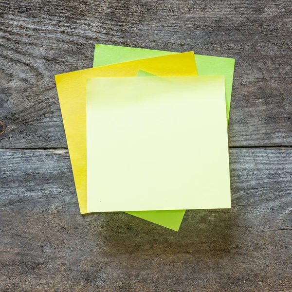 Sticky notes isolated on wooden background — Stock Photo, Image