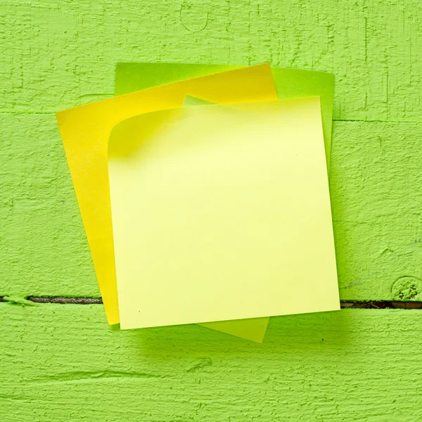 Sticky notes isolated on wooden background — Stock Photo, Image