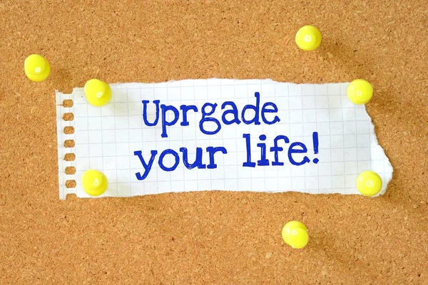 The phrase Upgrade Your Life typed on a piece of paper