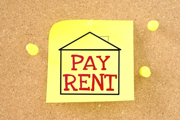 Sticky note with a message - pay the rent. — Stock Photo, Image