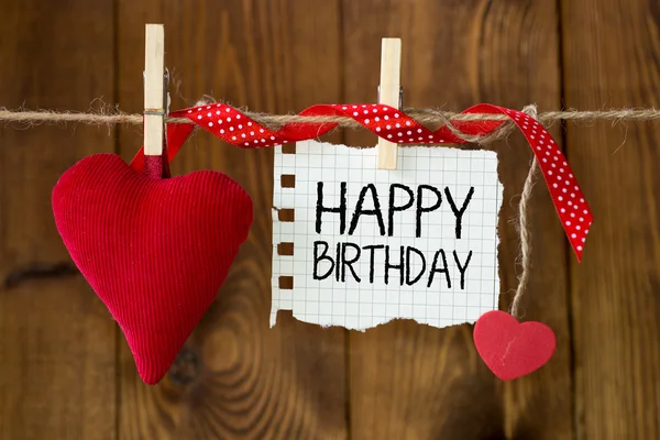 Happy birthday message written on a paper hanging on the clothesline — Stock Photo, Image