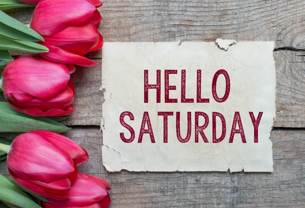 Tulipanes y papel con texto Hello Saturday —  Fotos de Stock