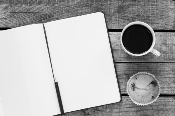 Notebook with coffee and cupcake — Stock Photo, Image