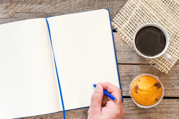 Man holding pencil above notebook — Stock Photo, Image