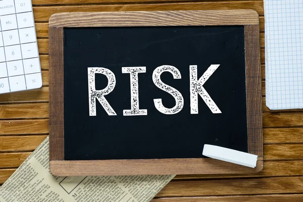 Risk Handwritten with white chalk on a blackboard — Stock Photo, Image