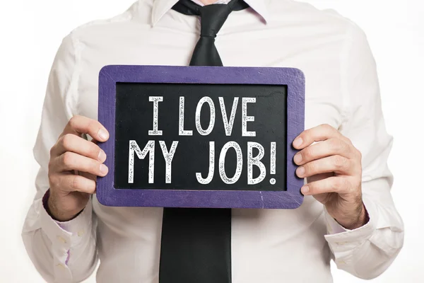 I love my job Handwritten on a blackboard which holding man — Stock Photo, Image