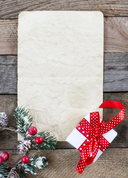 Sheet of paper with Christmas present — Stock Photo, Image