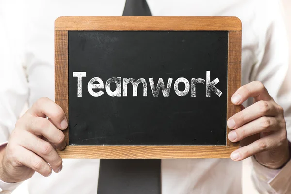 Zakenman met teamwerk woord — Stockfoto