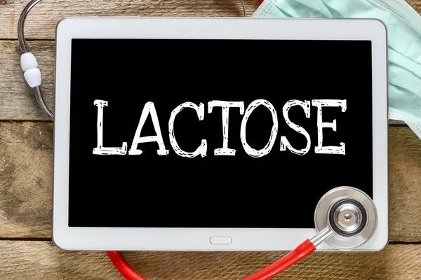 Tablet pc with word Lactose — Stock Photo, Image