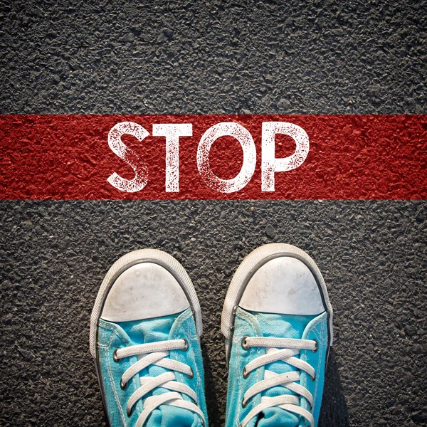 Male sneakers  and word stop — Stock Photo, Image