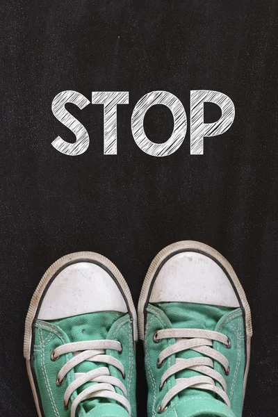 Male sneakers and word  stop — Stock Photo, Image