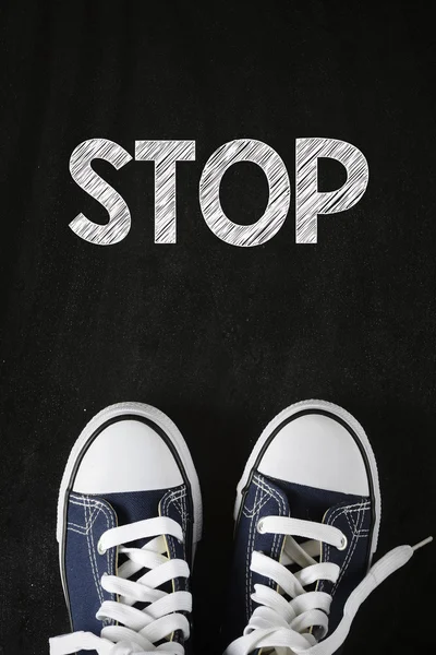 Male sneakers with stop word — Stock Photo, Image