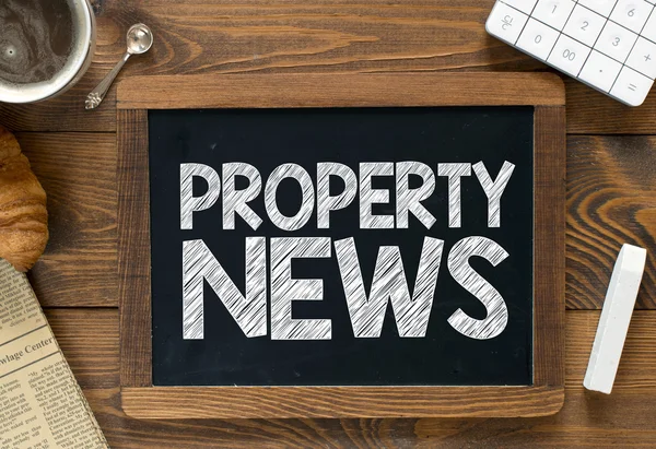 Property news handwritten on  blackboard — Stock Photo, Image