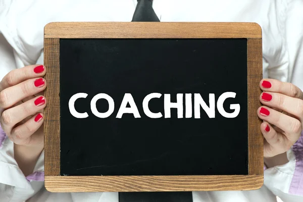 Tavlan med coaching word — Stockfoto