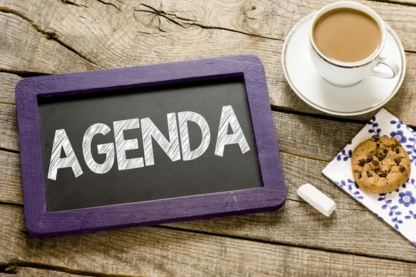 Agenda on blackboard with coffee — Stock Photo, Image