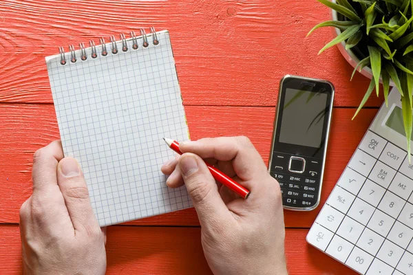 Man with notepad and calculator — Stock Photo, Image