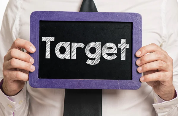 Businessman holding board  with target — Stock Photo, Image