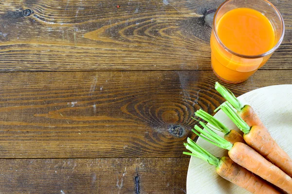 Bunch of fresh carrots and juice — Stock Photo, Image