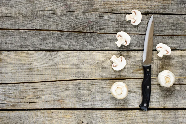Champignons mushrooms and knife — Stock Photo, Image