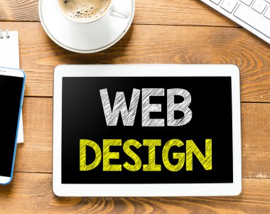 Tablet pc with web design and coffee