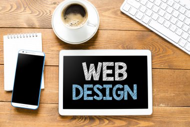 Tablet pc with web design and coffee