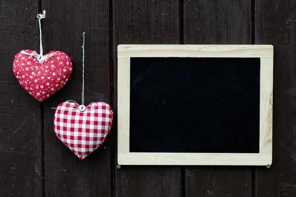 Blackboard decorated and handmade hearts Royalty Free Stock Photos