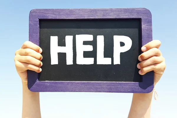 Hands holding blackboard with help — Stock Photo, Image