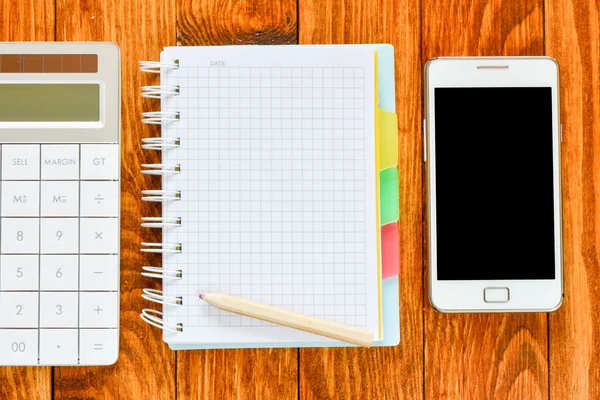 Bloc de notas con smartphone y calculadora — Foto de Stock