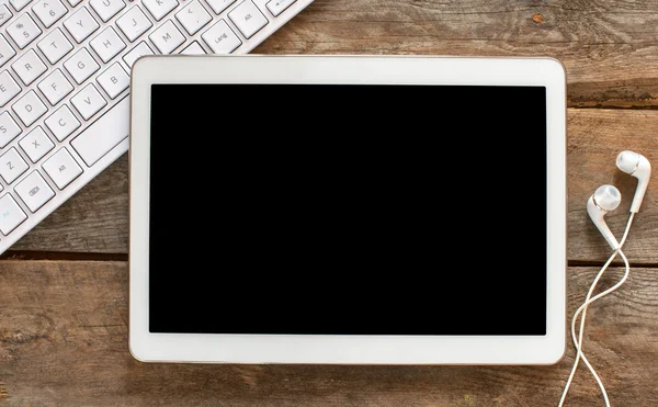 Tablet pc with headphones, keyboard — Stock Photo, Image