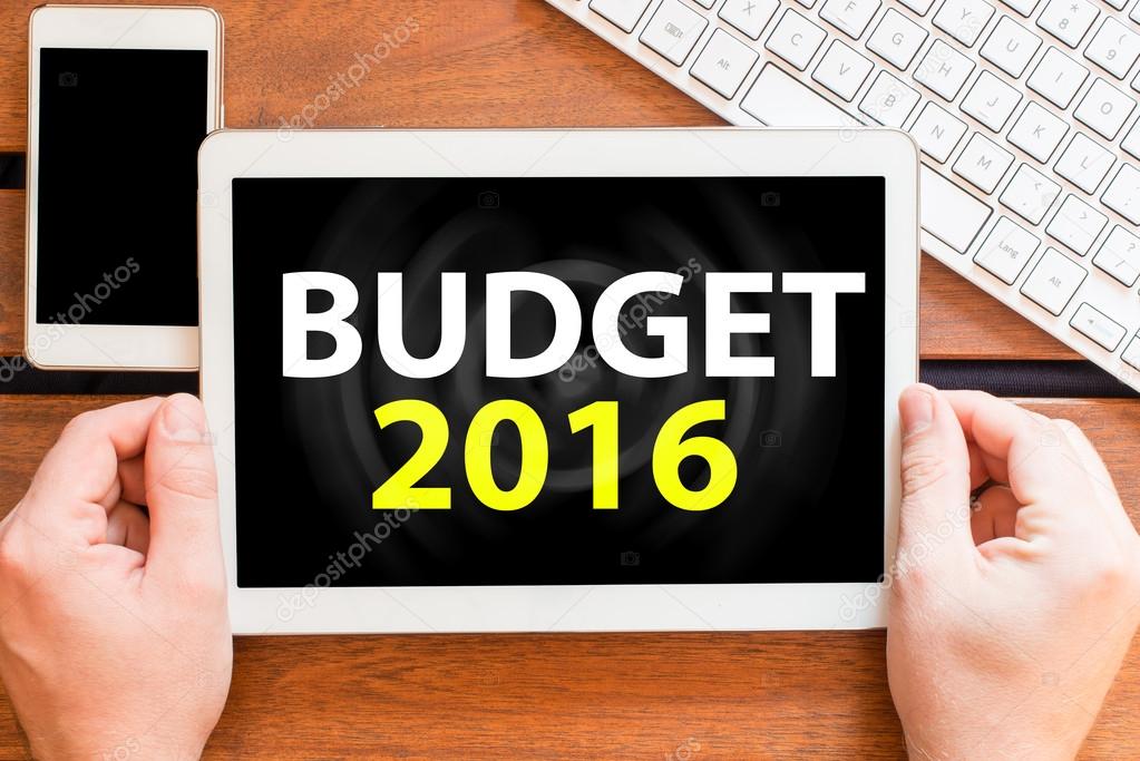 hands holding tablet pc with budget 2016