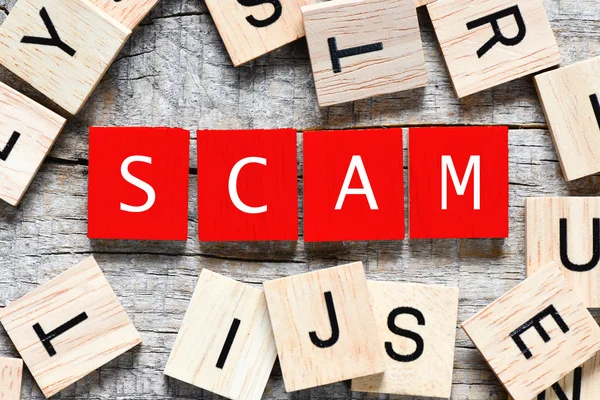 Wooden letters spelling SCAM — Stock Photo, Image