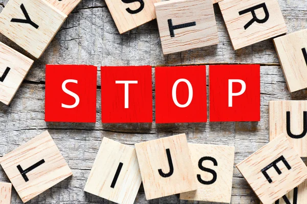 Wooden letters spelling stop — Stock Photo, Image