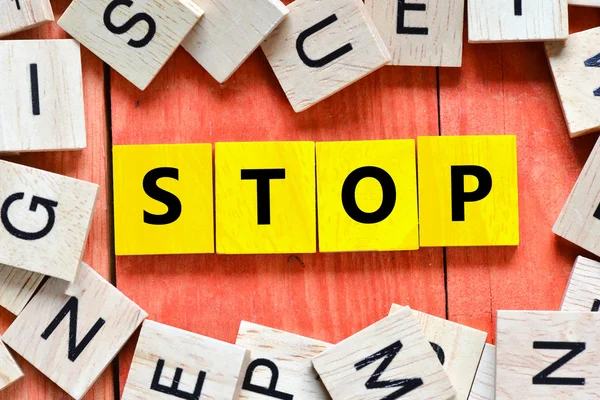 Wooden letters spelling stop — Stock Photo, Image