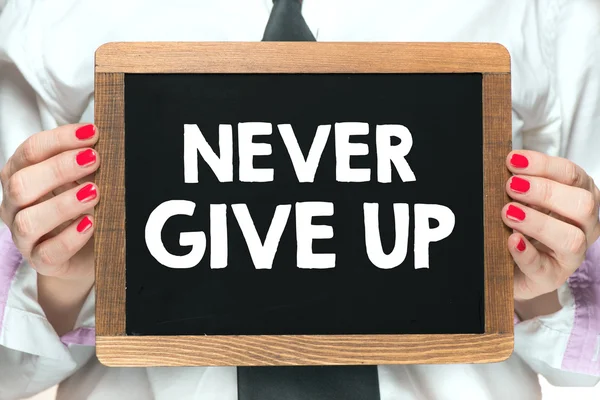 Hands with never give up inscription — Stock Photo, Image