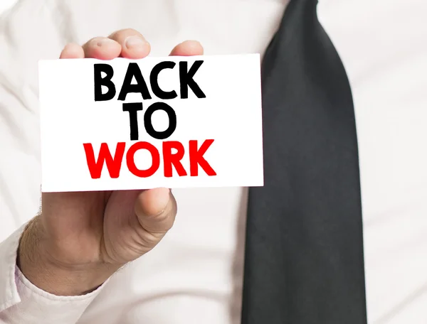 Hand with back to work card — Stock Photo, Image