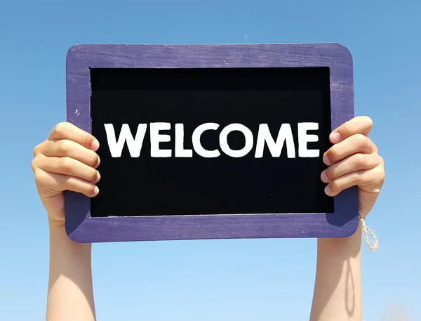 Hands holding blackboard with  welcome — Stock Photo, Image