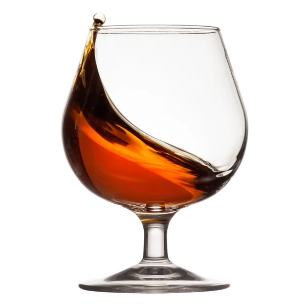 Splash of cognac in glass — Stock Photo, Image