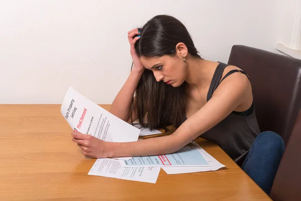 young woman worried over bills