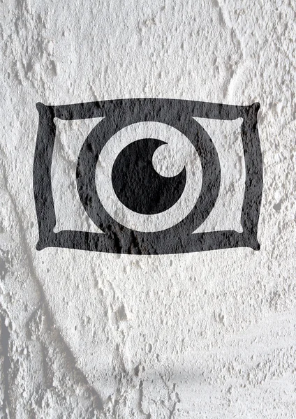 Oog pictogram Characterdesign op cement muur textuur achtergrond — Stockfoto