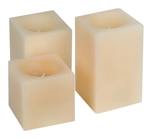 Three Beige Wax Candles Square Shape Isolated White — Stock Photo, Image