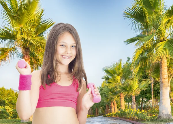 Girl and dumbbell — Stock Photo, Image