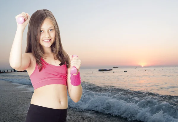 Girl and dumbbell — Stock Photo, Image